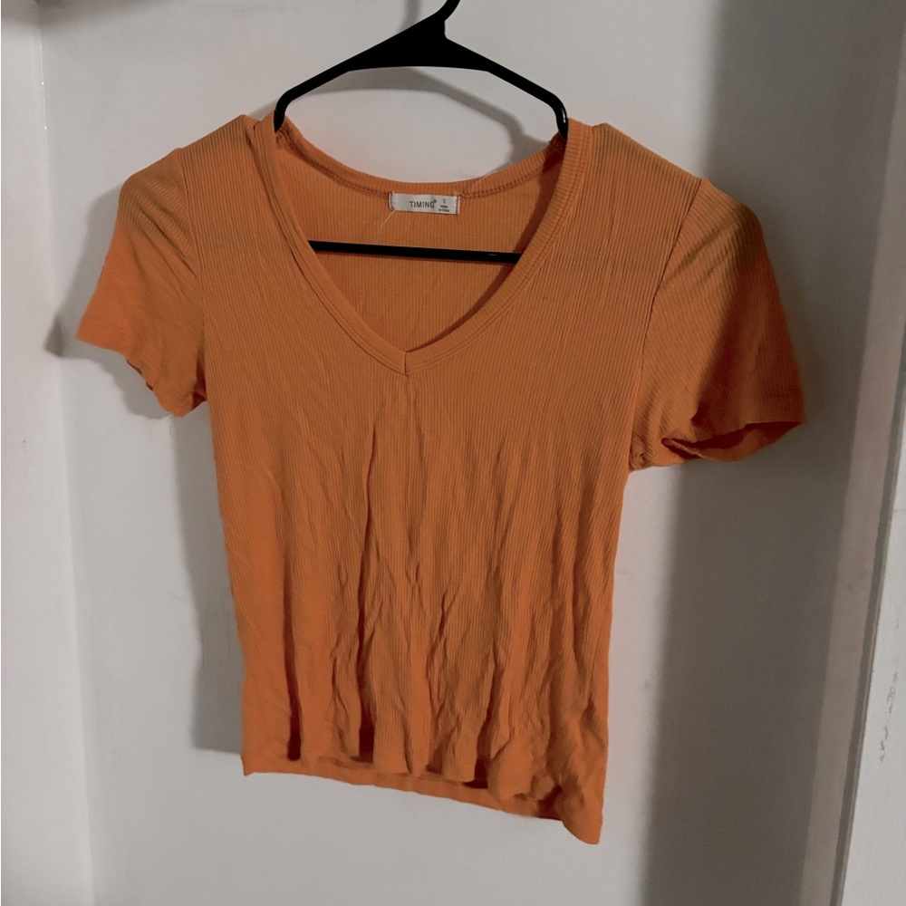 Light-weight, short sleeve, orange, ribbed shirt.